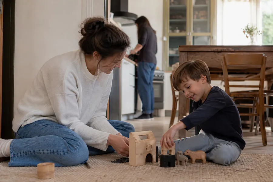 Une Boulotière joue avec un enfant de quatre ans